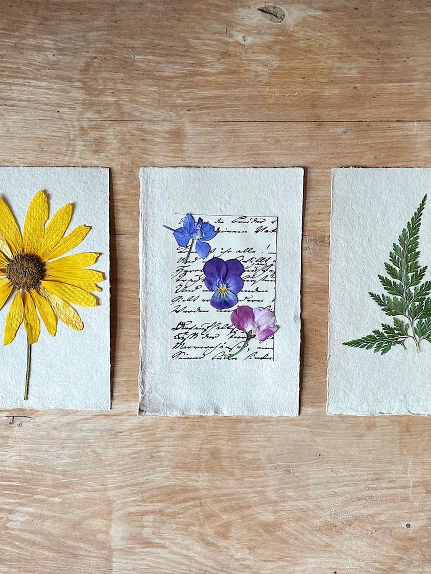 Torn paper collage with knit sleeve and pressed flowers