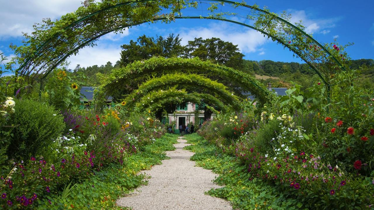 Garden path with cream linen on a stone bench